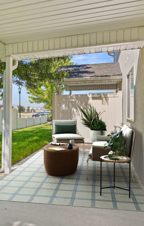 a patio with a chair and a table on it
