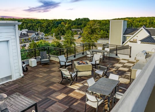 a patio with a fire pit and a dining table and chairs