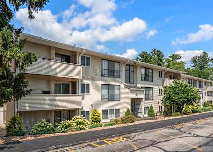 Apartment complex with a road in front of it.