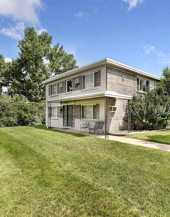 A house with a well-maintained lawn in front.