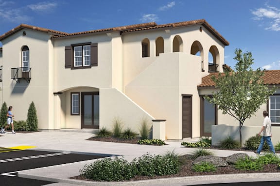 A modern house with a beige exterior and a red tile roof.