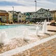 A pool with a fountain in the middle of it.