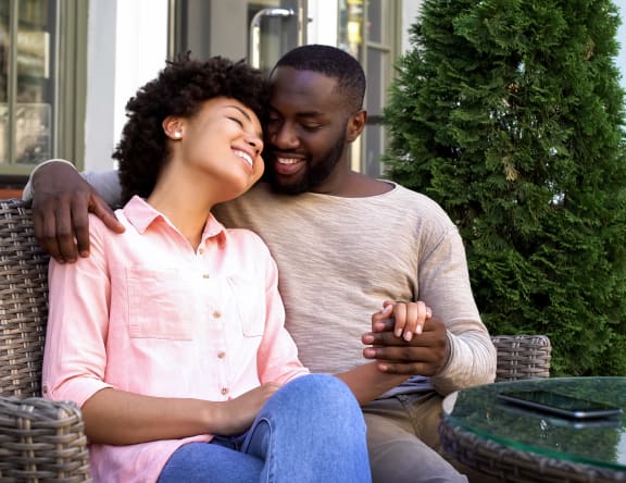 Happy couple sitting outside