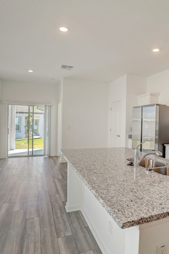 a bedroom with hardwood floors and white walls