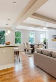 a living room and dining room with a couch and a table