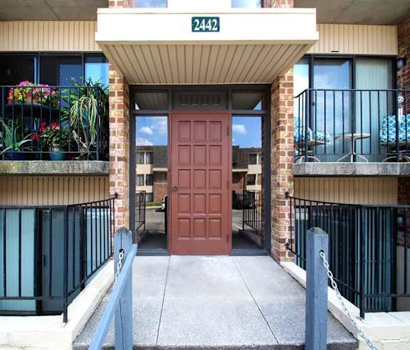 the entrance to a building with a red door