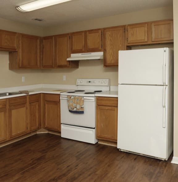 kitchen with white appliances and wooden cabinets  at Brookside Pointe, Travelers Rest, SC 29690