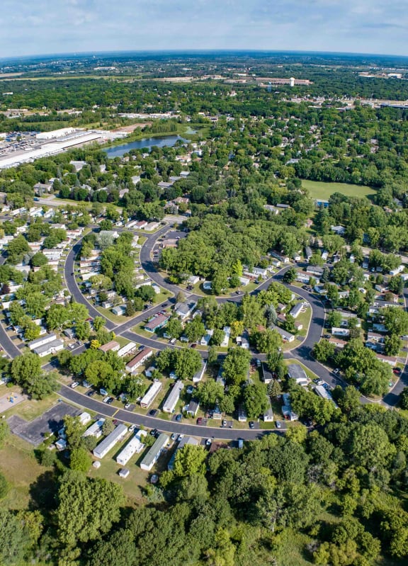 an aerial view of a neighborhood with cars parked in the street