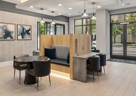 A modern office lobby with a reception desk and seating area.