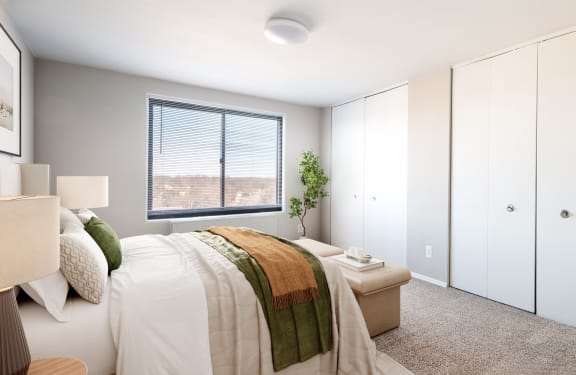 an empty bedroom with a bed and a window