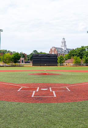 A baseball field with a red diamond in the center.