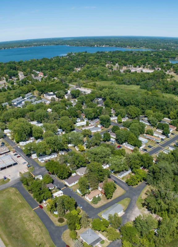 an aerial view of a neighborhood with trees and a parking lot