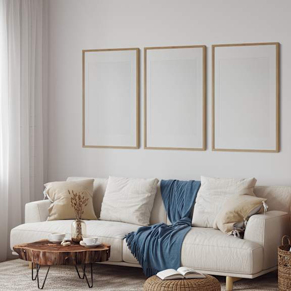 A living room with a white couch, a coffee table, and a wicker cabinet.