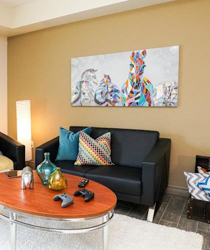 a living room with black couches and a coffee table
