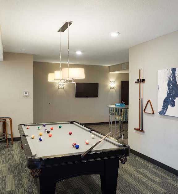 a game room with a pool table and a tv at Gabella at Parkside, Minnesota, 55124