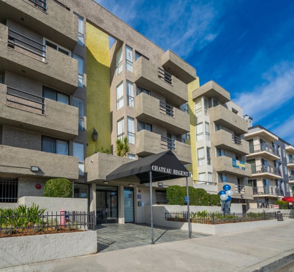 our apartments have a large pool and a building with palm trees