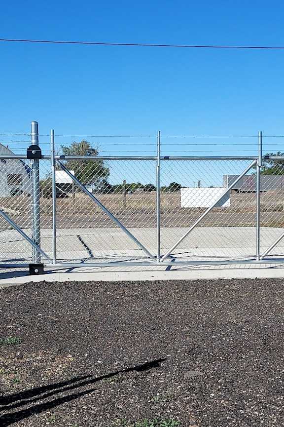 a gate into a fenced in area with a chain link fence