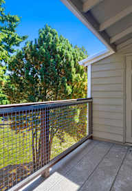 A balcony with a metal railing and a white door.