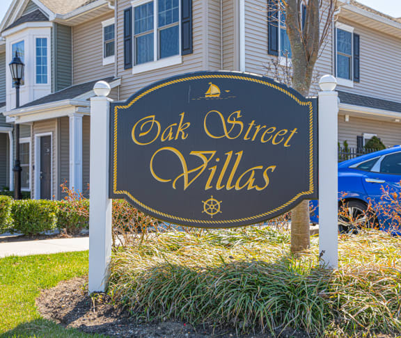 a sign in front of a house that reads oak street villas