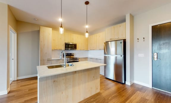 rendering of 2br C5 unit, view of kitchen with island, built in desk, upscale finishes