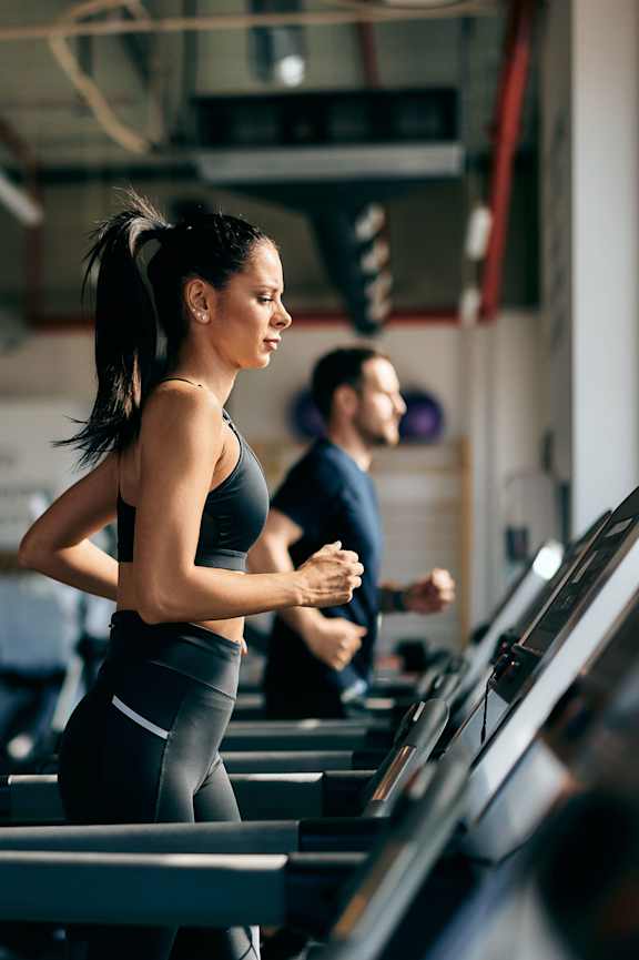 A woman is running on a treadmill in a gym at Bellary Flats , Summerville, South Carolina