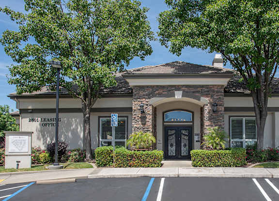 A clubhouse with a parking lot in front of it at Stoneridge Apartments, California, 95661