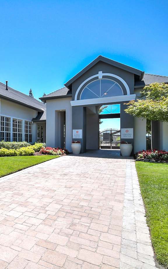 Leasing office entrance with paver walkway and landscaping at Rosemeade Apartments, California, 95661