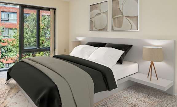a bedroom with a bed and a large window at Residences at Manchester Place, Manchester, 03101
