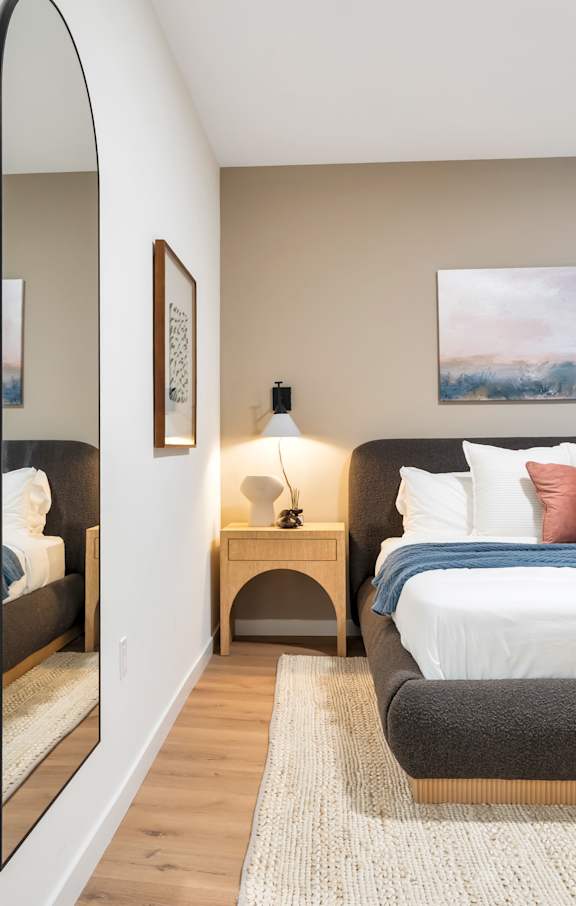 A Bedroom With a Full Size Mirror at Hue Soul Apartments, New Jersey