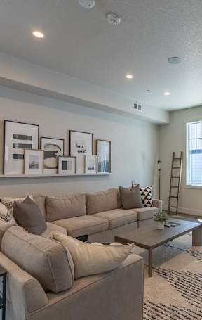 A modern living room with a fireplace and a large window l at Sandyplace Apartment Homes, Sandy, Oregon