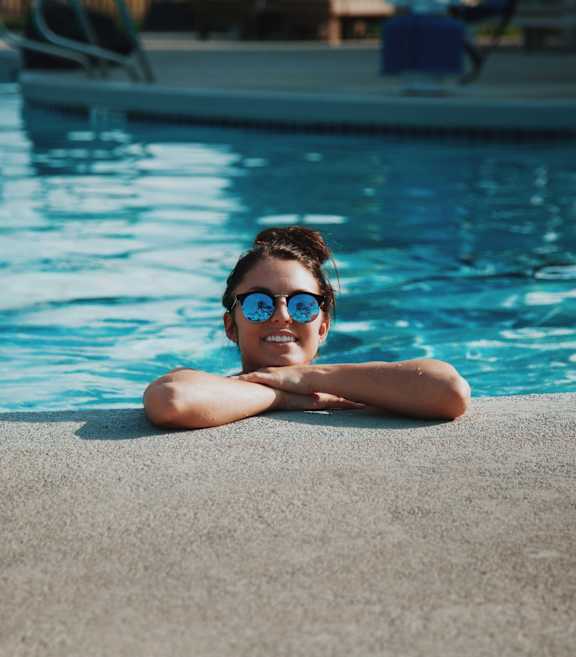 A person is relaxing by the poolside.