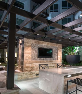 an outdoor entertaining area with a fireplace and patio furniture