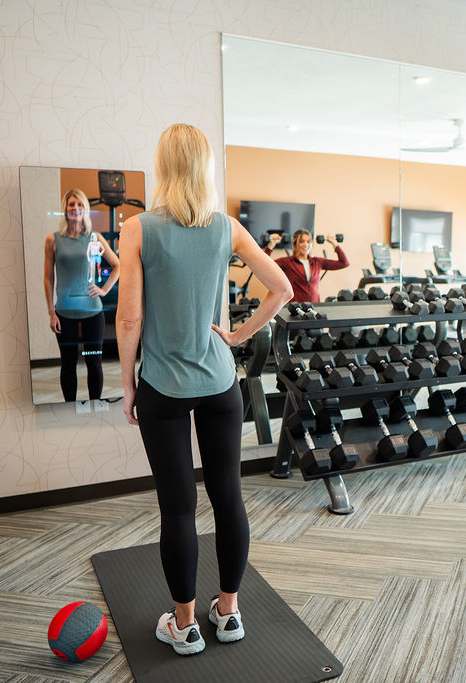 A spacious gym with a variety of equipment including treadmills, stationary bikes, and weight machines. at Sagebrook Apartments, La Vista, Nebraska