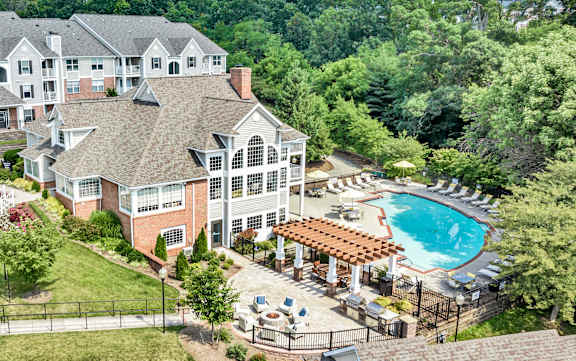 A large building with a pool in front of it. at Sunscape Apartments, Virginia, 24018