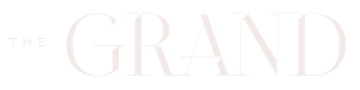The image shows a logo with the words "THE GRAND" in white text on a black background.