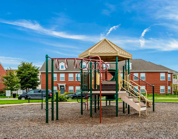 a green and beige playground at Horace Mann Apartments and townhomes in Gary, IN