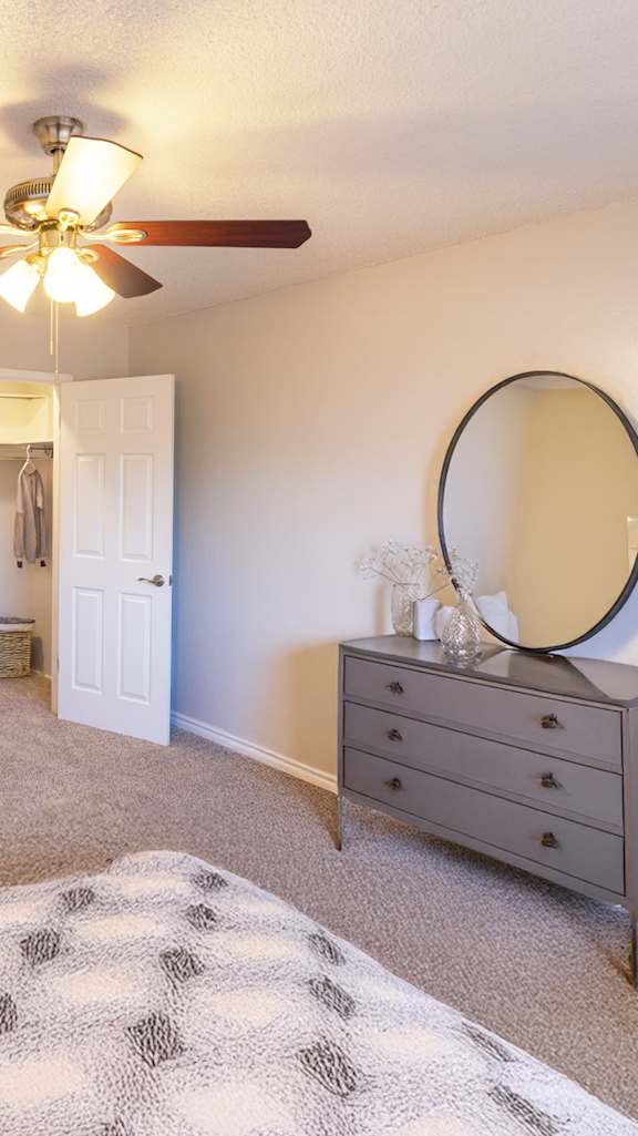 A living room with a white table and a television on a cabinet.