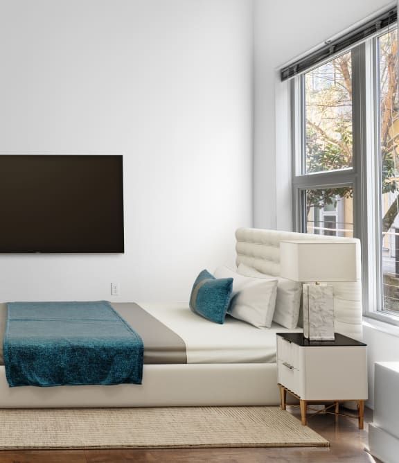 a bedroom with a bed and a painting on the wall