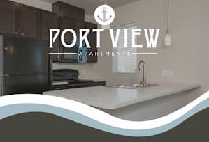 A kitchen with a black fridge and a countertop with a sink.