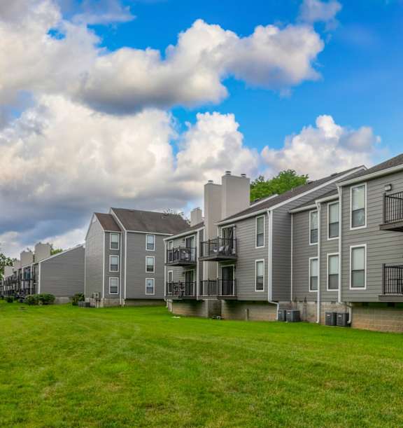 Fresh green grass with a grey apartment building