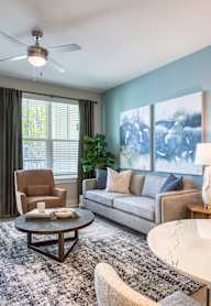 A living room with a white table and a brown chair.