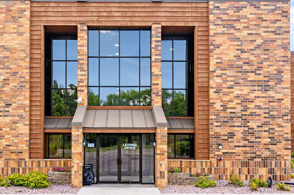 the front of a brick building with a glass door