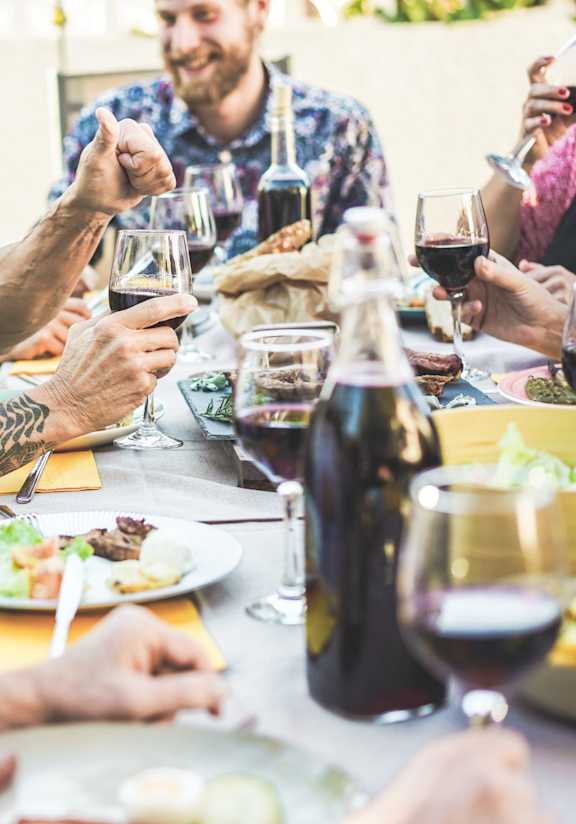 A group of people enjoying a meal and drinks together.
