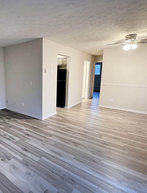 an empty living room with wood flooring and white walls at Hunter Ridge Apartments, Ohio, 45244