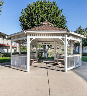 A gazebo is in the middle of a concrete courtyard. at Canyon Shadows Apartments, Riverside