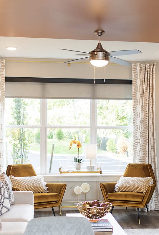 a living room with a ceiling fan and a large window at The Yards at Malvern, Pennsylvania