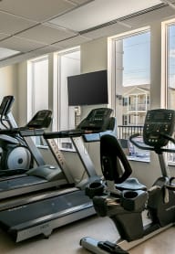 A fitness center with cardio equipment at Cedars at Carver Park 