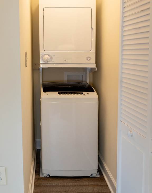 A small laundry room with a washer and dryer.