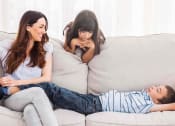 Thumbnail 19 of 24 - Residents relaxing in their modern apartment living room