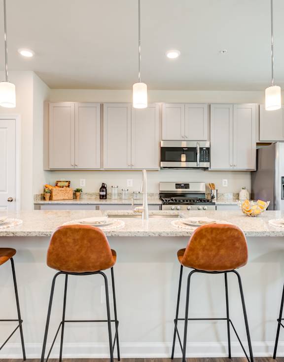 Kitchen with an Island and Brown Stools at Refinery Row in Baltimore, MD 21224